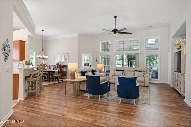 32 Aspen Hall Rd, Bluffton, SC 29910 - living area with a healthy amount of sunlight, wood finished floors, and ceiling fan with notable chandelier