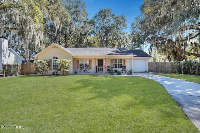 ranch-style house featuring concrete driveway, a front lawn, and fence