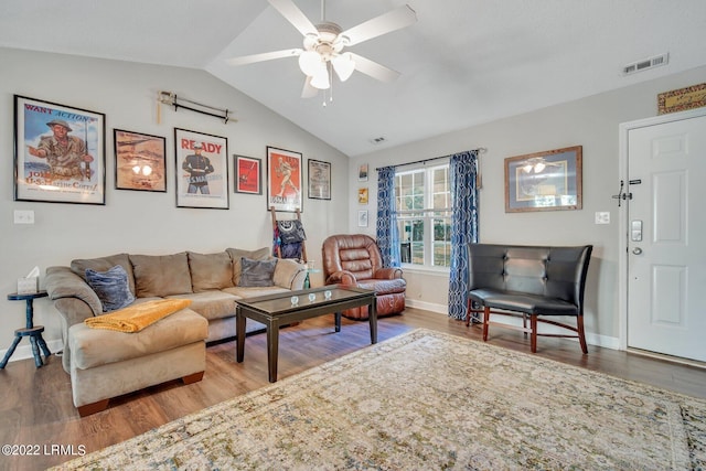 living room featuring baseboards, visible vents, vaulted ceiling, and wood finished floors