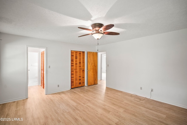 806 Coates Ln, Beaufort, SC 29902 - unfurnished bedroom featuring light wood finished floors, baseboards, a closet, a textured ceiling, and ensuite bath
