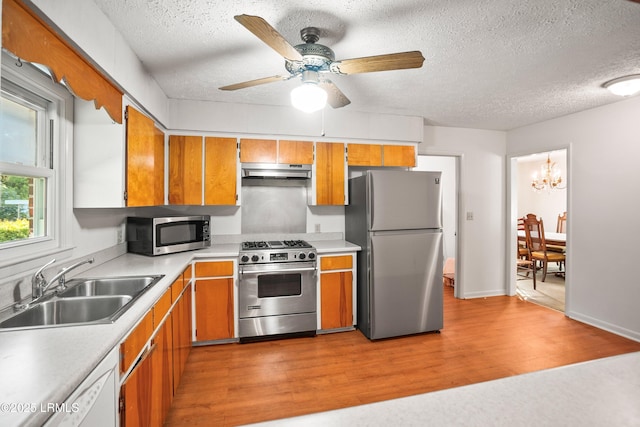 806 Coates Ln, Beaufort, SC 29902 - kitchen featuring appliances with stainless steel finishes, under cabinet range hood, a sink, a textured ceiling, and light countertops
