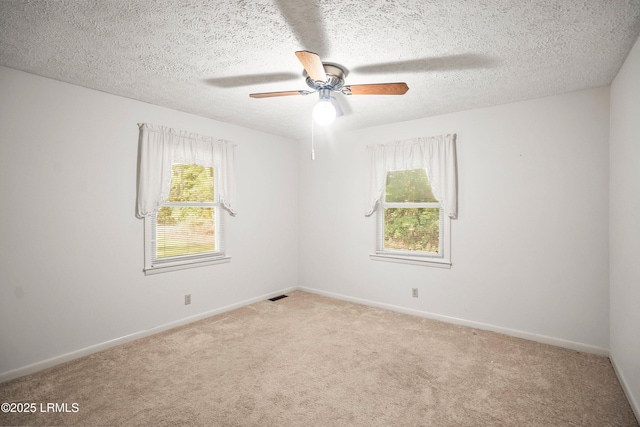 806 Coates Ln, Beaufort, SC 29902 - spare room with carpet floors, a ceiling fan, baseboards, and a textured ceiling