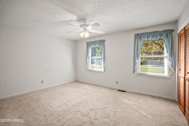 806 Coates Ln, Beaufort, SC 29902 - spare room featuring carpet floors, a ceiling fan, a textured ceiling, and baseboards