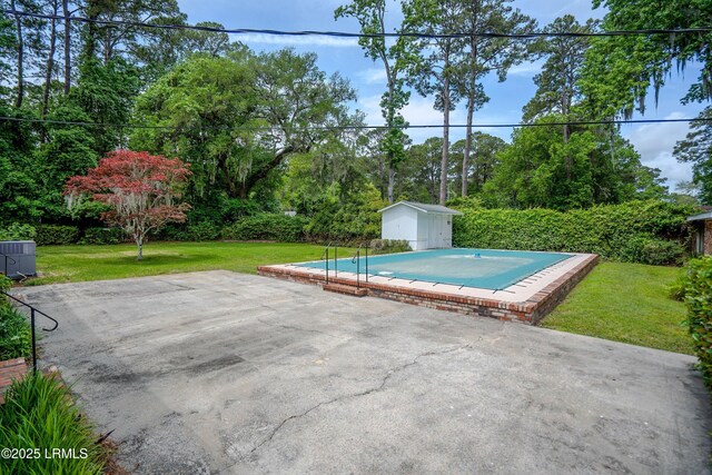 806 Coates Ln, Beaufort, SC 29902 - view of pool featuring a storage unit, an outdoor structure, a lawn, a patio, and central air condition unit