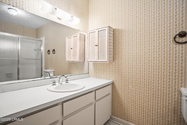 806 Coates Ln, Beaufort, SC 29902 - bathroom with toilet, wallpapered walls, a shower with door, and vanity