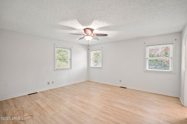 806 Coates Ln, Beaufort, SC 29902 - spare room featuring light wood-style floors, ceiling fan, a textured ceiling, and baseboards