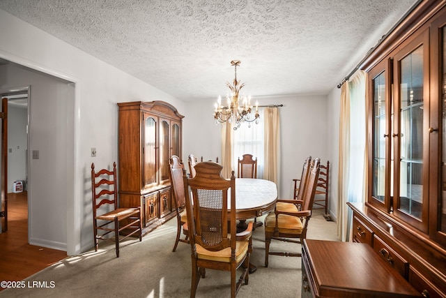 806 Coates Ln, Beaufort, SC 29902 - dining room featuring a chandelier, a textured ceiling, baseboards, and light colored carpet
