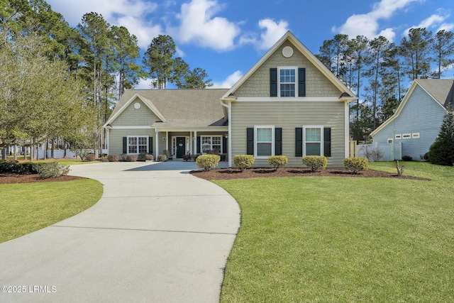 craftsman-style home featuring a front yard, concrete driveway, and fence