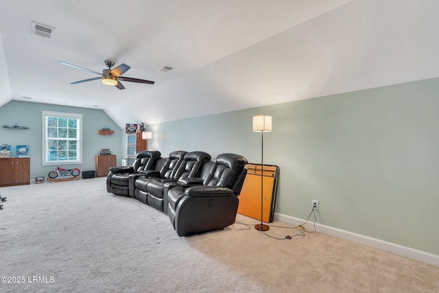 carpeted home theater room featuring visible vents, vaulted ceiling, baseboards, and ceiling fan