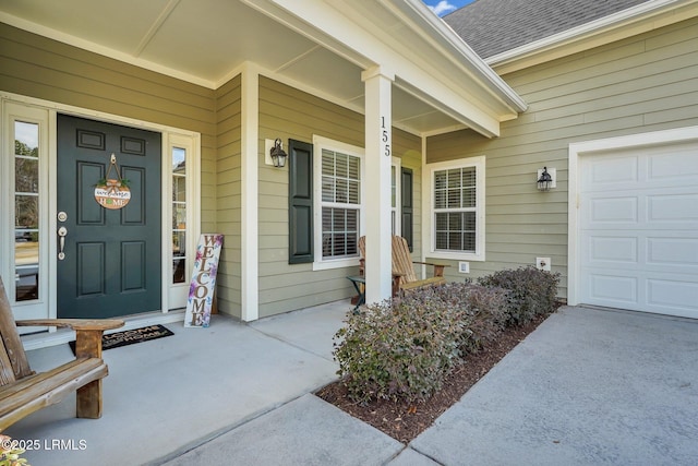 view of exterior entry featuring covered porch and roof with shingles