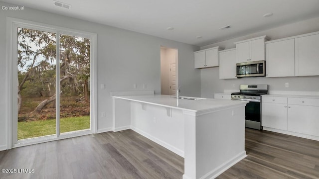 134 Twickenham Loop, Yemassee, SC 29945 - kitchen featuring stainless steel appliances, dark wood-style flooring, white cabinets, light countertops, and a peninsula