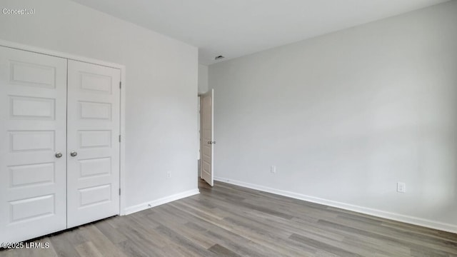 134 Twickenham Loop, Yemassee, SC 29945 - unfurnished bedroom featuring wood finished floors and a closet