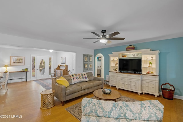 living room with ceiling fan and light wood-type flooring