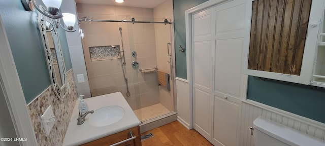 bathroom with vanity, wood-type flooring, toilet, and walk in shower