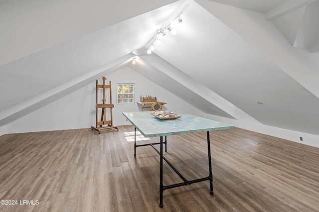 bonus room with hardwood / wood-style flooring and vaulted ceiling