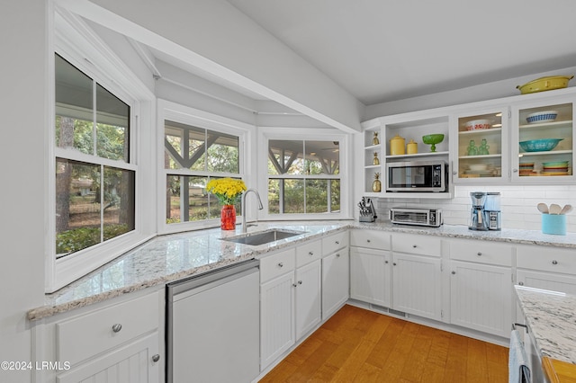 kitchen featuring backsplash, appliances with stainless steel finishes, sink, and white cabinets