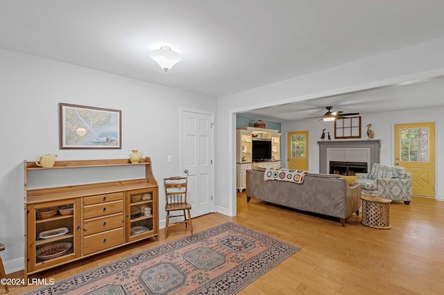 living room with ceiling fan and light hardwood / wood-style flooring