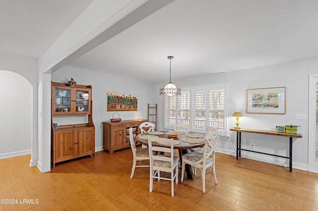 dining room with a notable chandelier and light hardwood / wood-style flooring