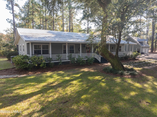 ranch-style house with covered porch and a front lawn