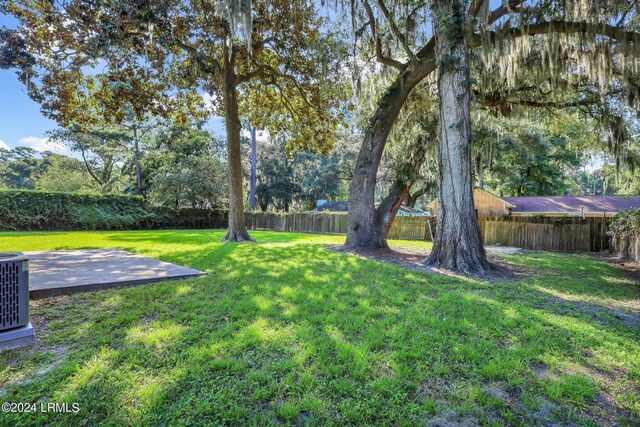 view of yard with a patio and central AC