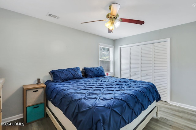 bedroom featuring hardwood / wood-style floors, a closet, and ceiling fan