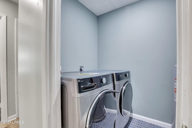 washroom with tile patterned floors and washer and clothes dryer