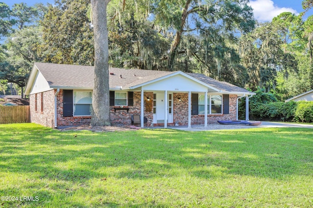 ranch-style house with covered porch and a front lawn