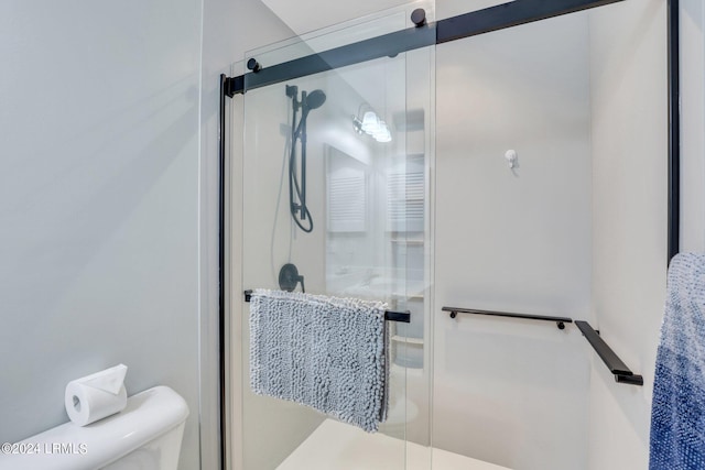 bathroom with toilet and walk in shower