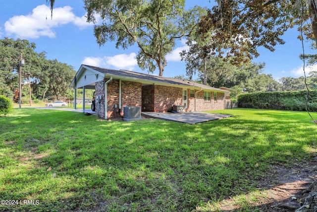 back of house with a patio area, central air condition unit, and a lawn