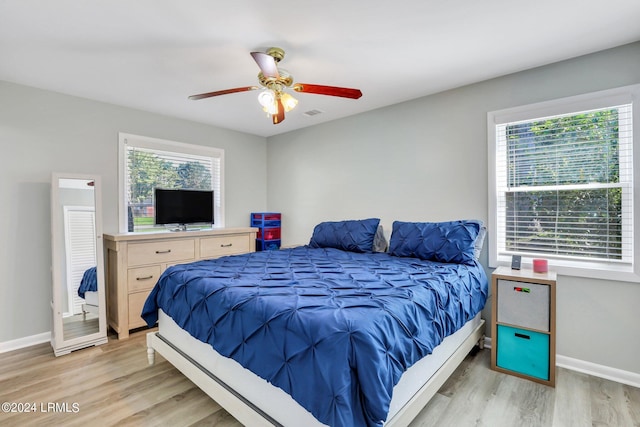 bedroom with ceiling fan and light hardwood / wood-style flooring