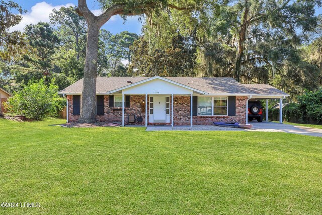 single story home with a carport, covered porch, and a front lawn