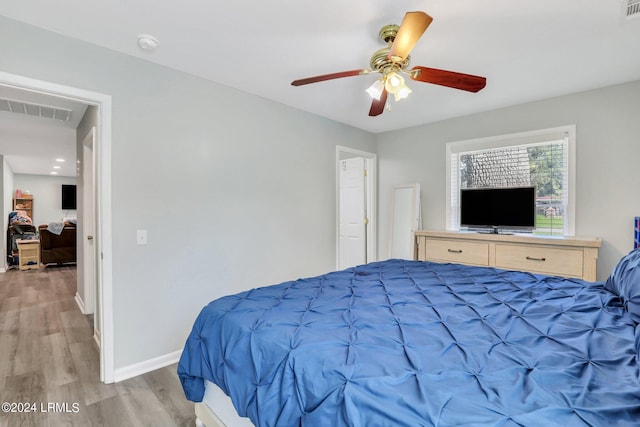 bedroom with light hardwood / wood-style floors and ceiling fan