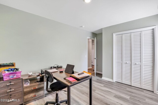 office with light hardwood / wood-style flooring