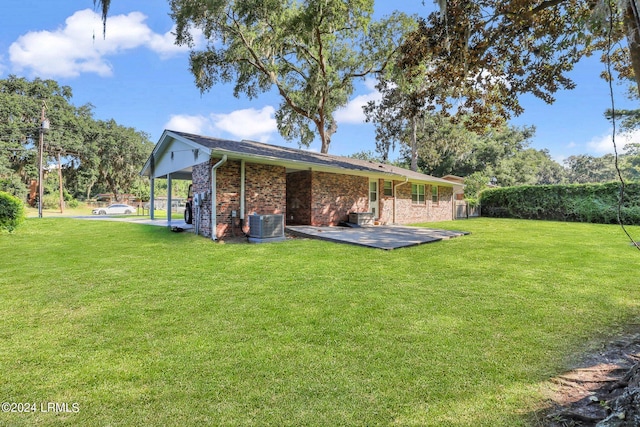 rear view of house with cooling unit and a lawn