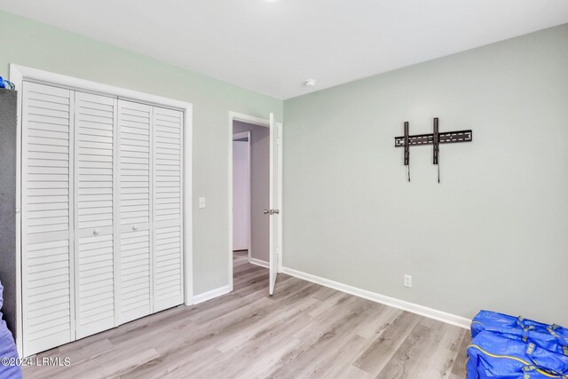 unfurnished bedroom with light wood-type flooring