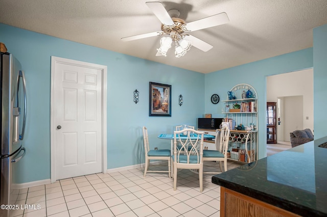1101 Beavers Den, Beaufort, SC 29902 - dining room featuring light tile patterned flooring, a textured ceiling, baseboards, and ceiling fan