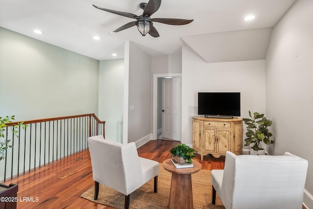 living room featuring hardwood / wood-style floors and ceiling fan