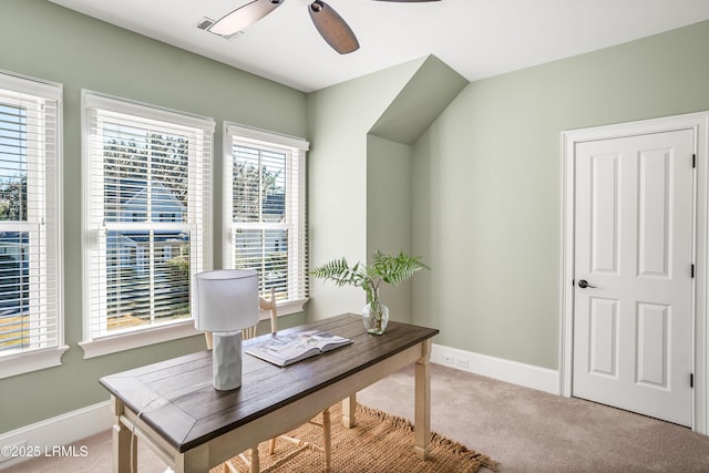 carpeted office space featuring ceiling fan