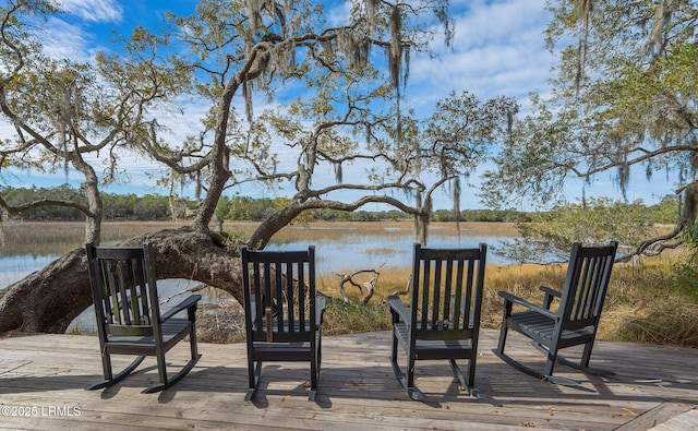 wooden terrace featuring a water view