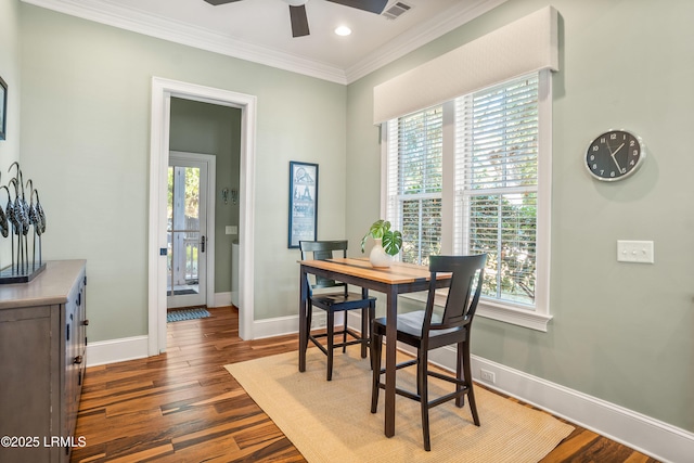 dining area featuring crown molding, ceiling fan, and dark hardwood / wood-style flooring