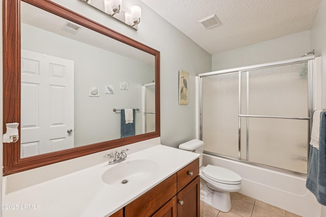 69 Wheatfield Cir, Bluffton, SC 29910 - full bath with vanity, tile patterned flooring, combined bath / shower with glass door, and a textured ceiling