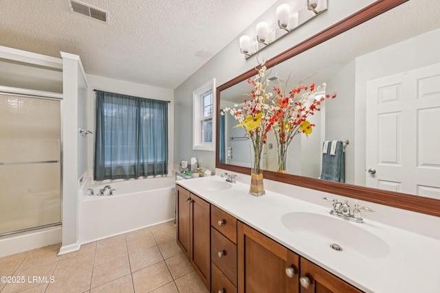 69 Wheatfield Cir, Bluffton, SC 29910 - full bathroom featuring double vanity, a garden tub, a textured ceiling, tile patterned floors, and a shower stall