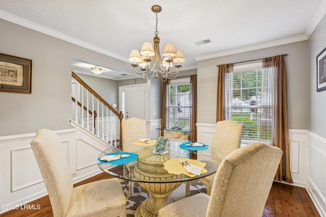 69 Wheatfield Cir, Bluffton, SC 29910 - dining space featuring a chandelier, wainscoting, stairs, crown molding, and wood finished floors