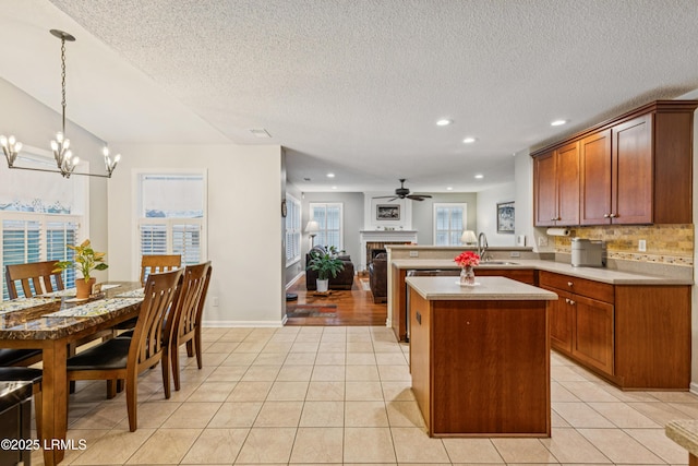 69 Wheatfield Cir, Bluffton, SC 29910 - kitchen with a fireplace, a chandelier, recessed lighting, a peninsula, and light countertops