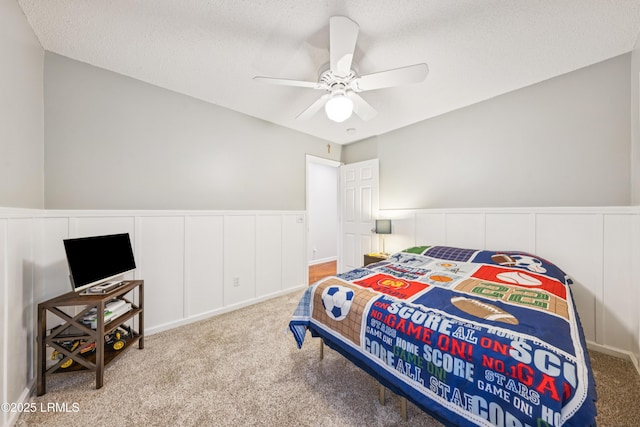 69 Wheatfield Cir, Bluffton, SC 29910 - bedroom featuring carpet, a wainscoted wall, ceiling fan, a decorative wall, and a textured ceiling