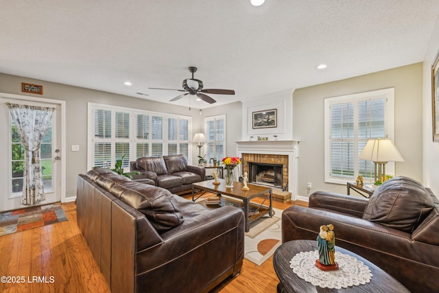 69 Wheatfield Cir, Bluffton, SC 29910 - living room with light wood finished floors, ceiling fan, a brick fireplace, and recessed lighting