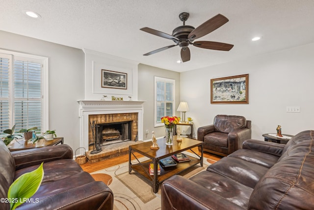 69 Wheatfield Cir, Bluffton, SC 29910 - living area with wood finished floors, recessed lighting, a ceiling fan, a fireplace, and a textured ceiling