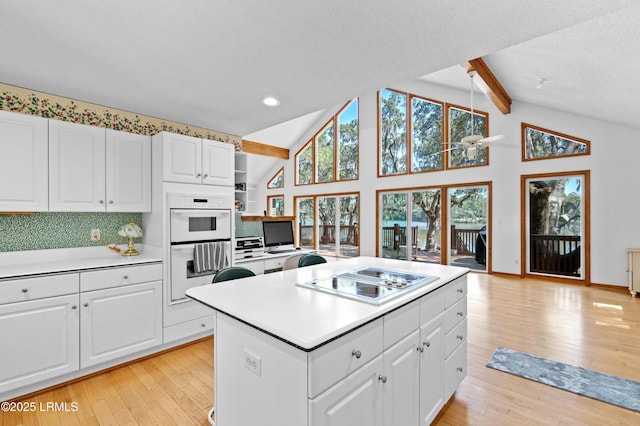 20 Ladys Walk, Beaufort, SC 29907 - kitchen featuring lofted ceiling with beams, light wood-type flooring, and stovetop with downdraft