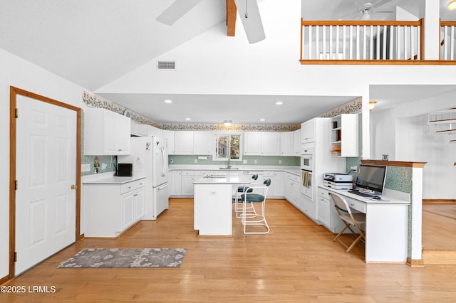 20 Ladys Walk, Beaufort, SC 29907 - kitchen with a ceiling fan, visible vents, light wood-style flooring, white cabinets, and a center island