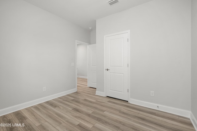 unfurnished bedroom with baseboards, visible vents, and light wood-style flooring